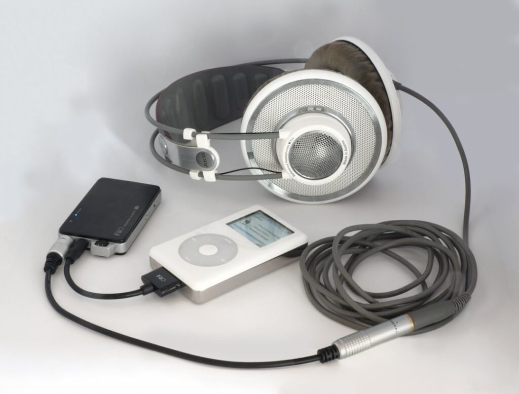 White headphones connected to an iPod and audio devices representing multi-sensory technology for language learning